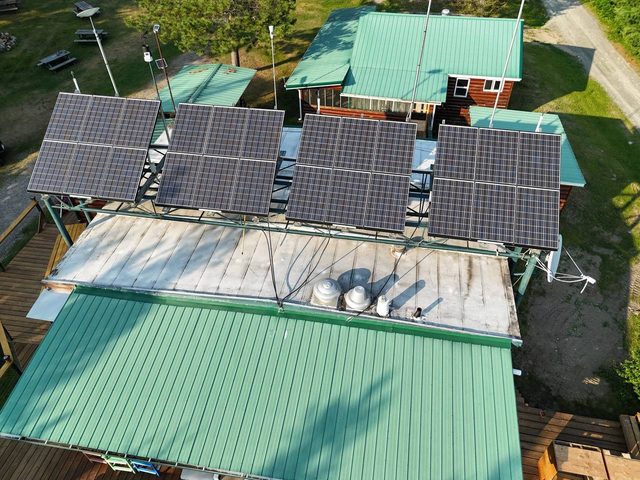 Cuttle Lake Resort, aerial still, 2026-07-10: the lodge roof and solar panels, straight down