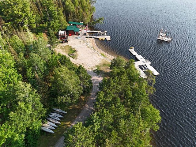 Cuttle Lake Resort, aerial still, 2026-07-10: the shoreline, the boat launch and canoes on the bank