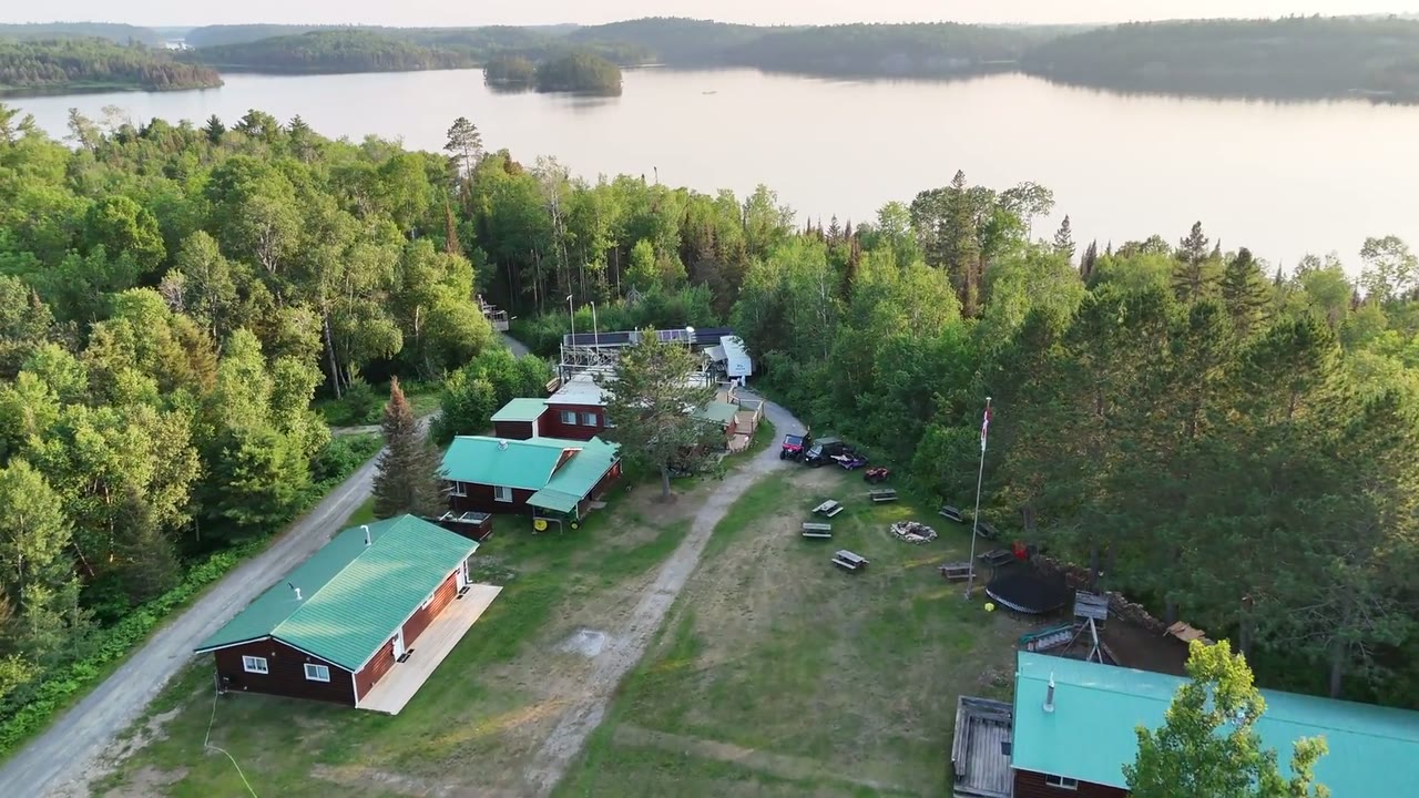 A frame from the Cuttle Lake Resort flythrough: the camp buildings and the lake from the rendered 3D model